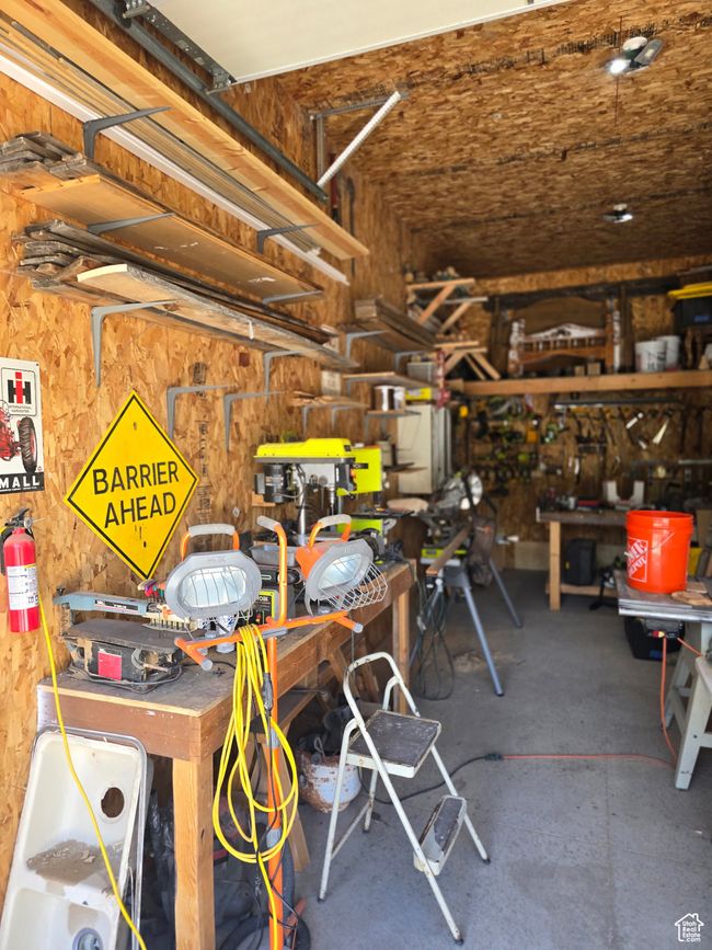 Garage featuring a workshop area | Image 69