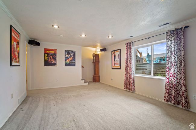 Empty room featuring visible vents, stairway, crown molding, and recessed lighting | Image 23