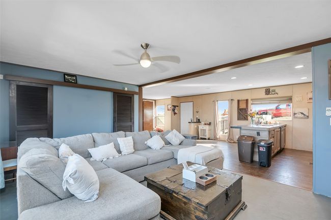 Living room with beamed ceiling, recessed lighting, a ceiling fan, and wood finished floors | Image 23