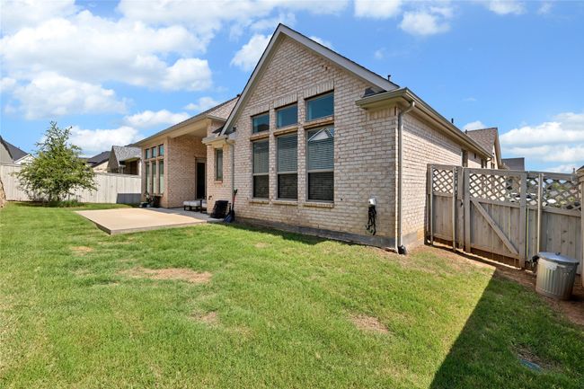 Rear view of house with a patio area and brick siding | Image 29
