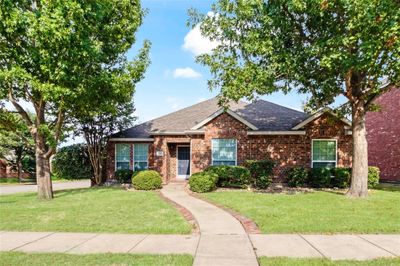 View of front facade with a front lawn | Image 1