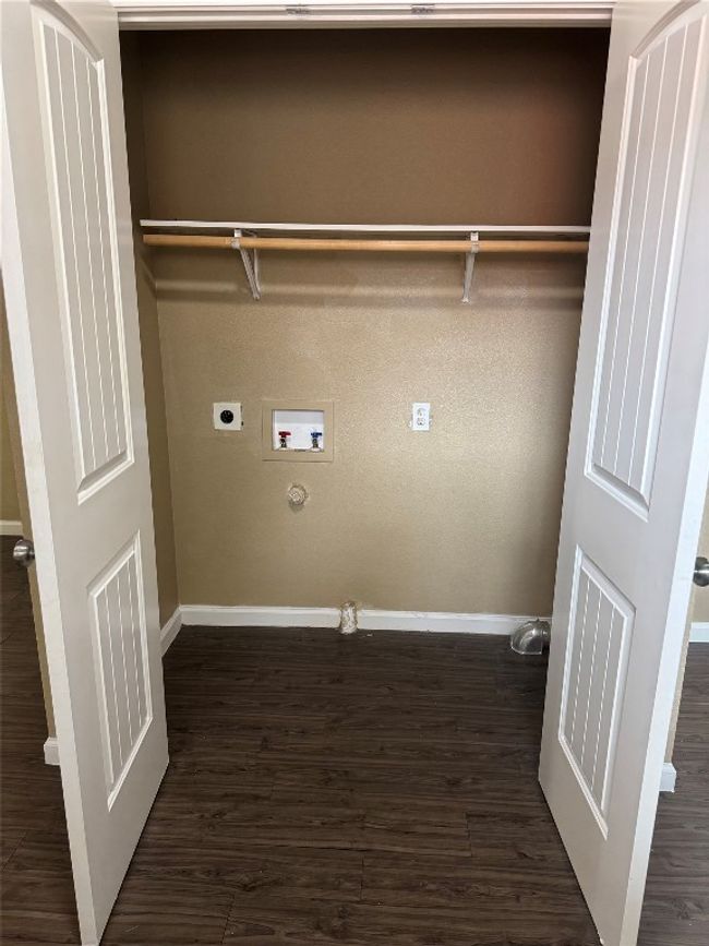 Laundry room with hookup for an electric dryer, hookup for a washing machine, dark wood-style floors, and gas dryer hookup | Image 5