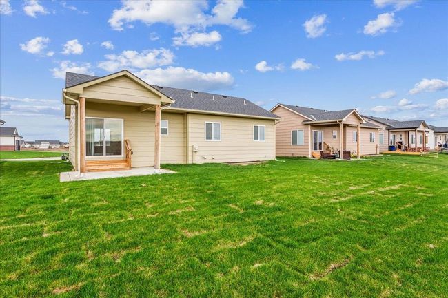 Rear view of house with entry steps and a lawn | Image 29