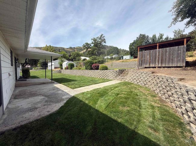 View of green lawn featuring a patio area | Image 10