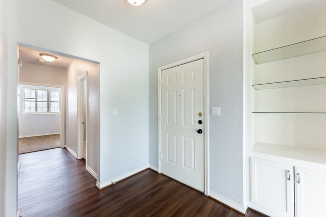 Foyer entrance featuring dark wood finished floors and baseboards | Image 6