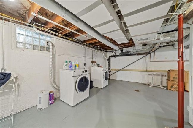 Basement featuring visible vents and washing machine and dryer | Image 23