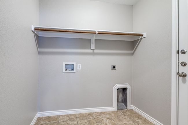 Clothes washing area with baseboards, washer hookup, laundry area, and hookup for an electric dryer | Image 13