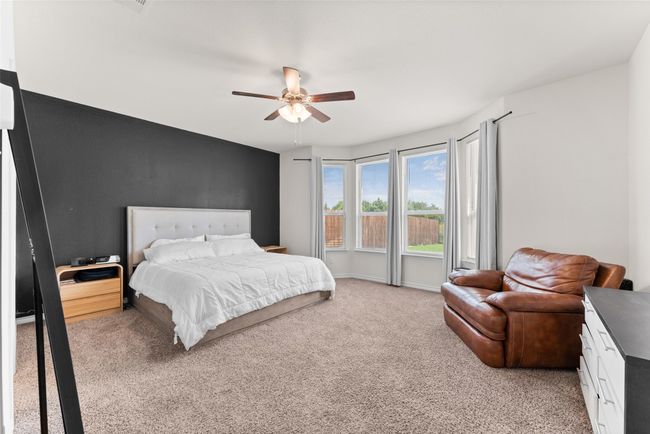 Bedroom with light carpet and a ceiling fan | Image 14
