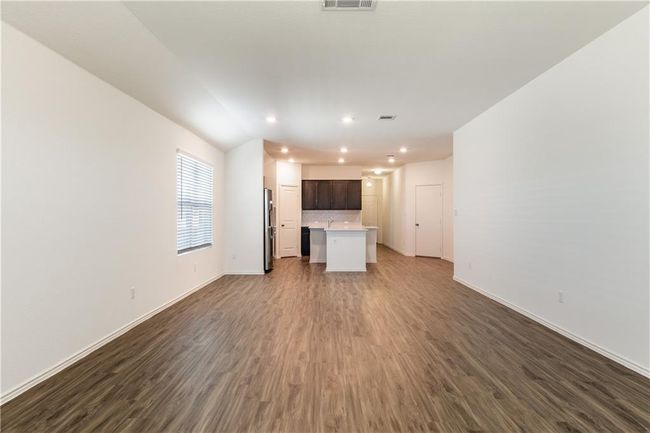 Unfurnished living room featuring dark wood-style flooring and recessed lighting | Image 6