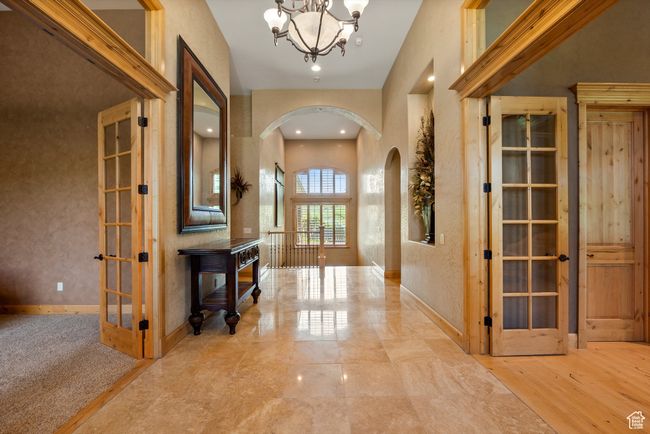 Foyer entrance with arched walkways, a chandelier, baseboards, and recessed lighting | Image 21
