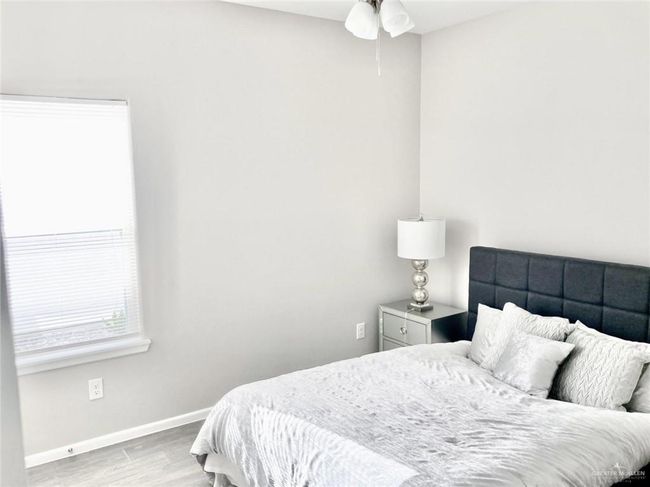 Empty room with wood finished floors and ceiling fan | Image 6