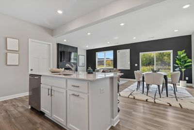 (Photo of model, actual homes finishes will vary) Enjoy plenty of seating at the kitchen island and dining area adjacent to the kitchen. Perfect for entertaining or having a family meal together. | Image 3