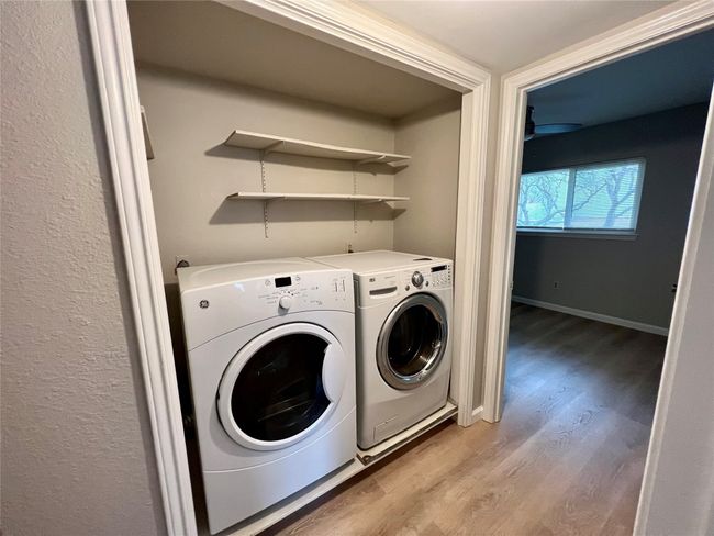 Laundry room featuring light wood-type flooring, washing machine and clothes dryer | Image 20