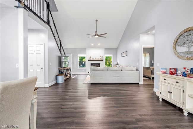 Living room with high vaulted ceiling, ceiling fan, and dark hardwood / wood-style flooring | Image 4