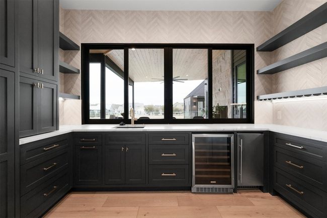 A pantry, with a wine fridge and sliding windows, makes serving guests a breeze | Image 15