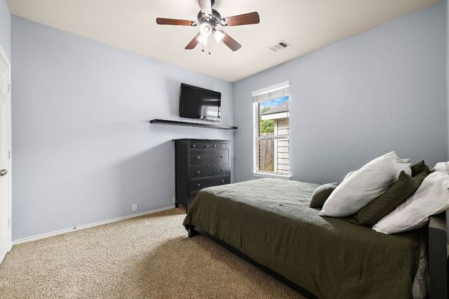 Bedroom featuring carpet floors, baseboards, and ceiling fan | Image 25