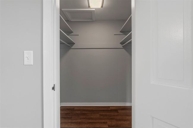 Primary walk in closet has shelving and space to hang your clothing. | Image 12