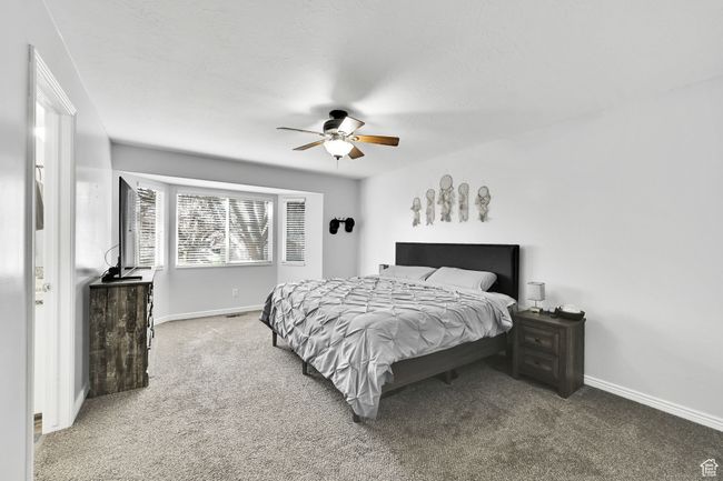 Bedroom with baseboards, carpet floors, and ceiling fan | Image 16