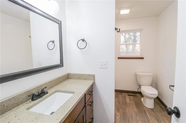 Bathroom with hardwood / wood-style floors, vanity, and toilet | Image 24