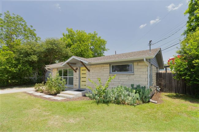 View of front facade with stone siding and a shingled roof | Image 4