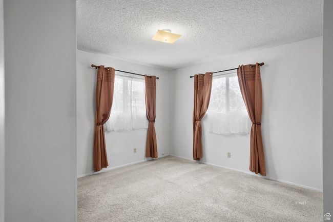Emptys, carpet flooring, a textured ceiling, and a healthy amount of sunlight | Image 21