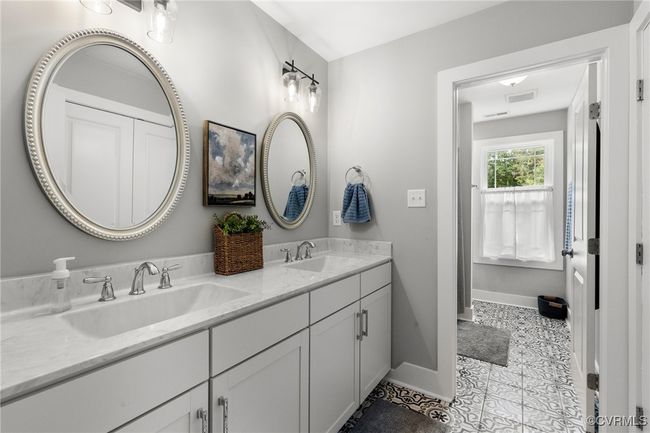 Bathroom featuring visible vents, a sink, baseboards, and double vanity | Image 27
