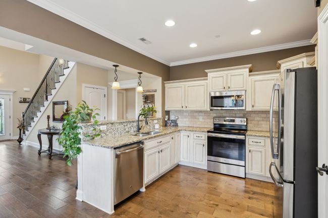 The kitchen boasts recessed lighting, crown molding, and sleek granite countertops. 1107 Sycamore Leaf Way Murfreesboro, TN 37129 | Image 8