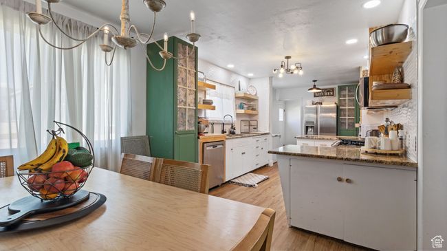 Dining room with a chandelier, light wood finished floors, and recessed lighting | Image 7