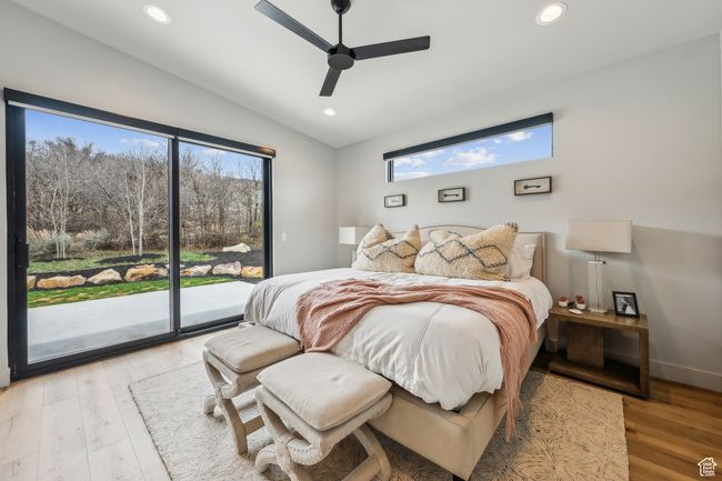 Bedroom with recessed lighting, vaulted ceiling, wood finished floors, and access to outside | Image 38