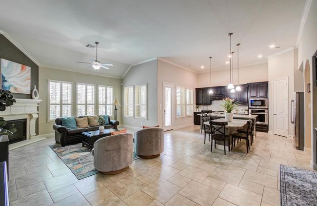 Open concept. Lots of natural lighting in the spacious living room and beautiful kitchen. | Image 7