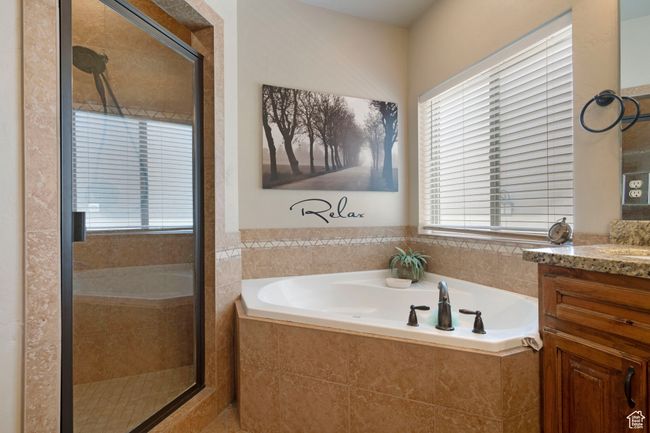 Full bathroom featuring vanity, a garden tub, and a stall shower | Image 17