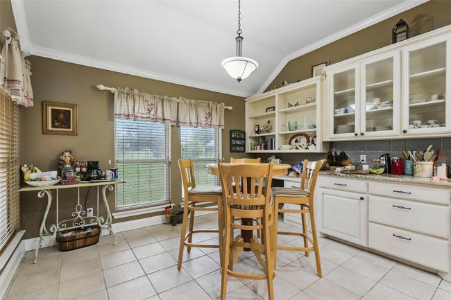 Dining room featuring lofted ceiling, crown molding, and light tile patterned floors | Image 15