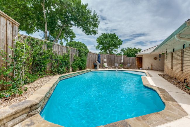 The fence has fragrant jasmine and gorgeous passion flowers growing on the many trellises along the back of the pool. | Image 25