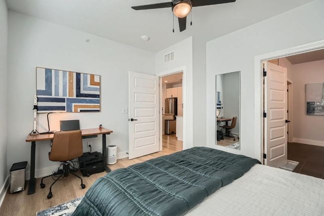 Master Bedroom with a desk, wood finished floors, and a ceiling fan | Image 13