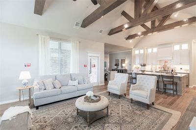 Living room featuring beam ceiling, high vaulted ceiling, plenty of natural light, and hardwood / wood-style floors | Image 3