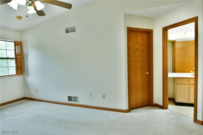 Carpeted spare room featuring ceiling fan and baseboards | Image 37