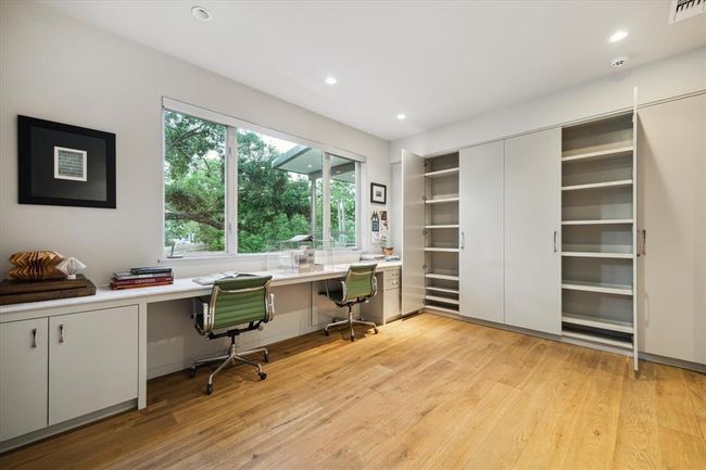 The versatile flex room with operable RAM windows that invite natural light and more of the welcomed treetop views, features a wall of custom storage cabinets just begging to be filled. Like so much in 2019 Du Barry, sleek, modern design pairs functionality with serenity. | Image 22