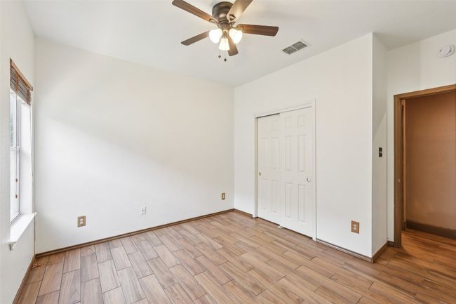 Unfurnished bedroom with light wood finished floors, baseboards, a closet, and a ceiling fan | Image 15