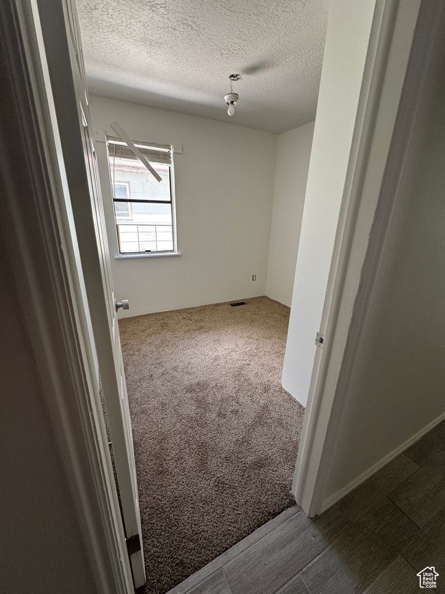 Carpeted empty room featuring a textured ceiling | Image 4