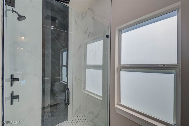 Full bathroom with a shower stall and plenty of natural light | Image 14