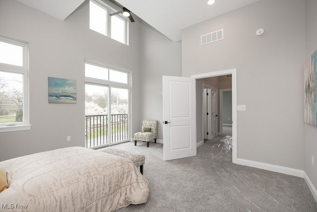 Carpeted bedroom with ceiling fan, a towering ceiling, and access to outside | Image 26