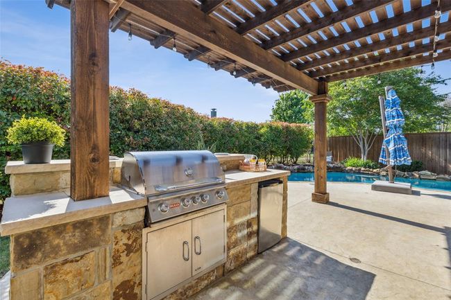 View of terrace with an outdoor kitchen, a pergola, a grill, and a fenced in pool | Image 29