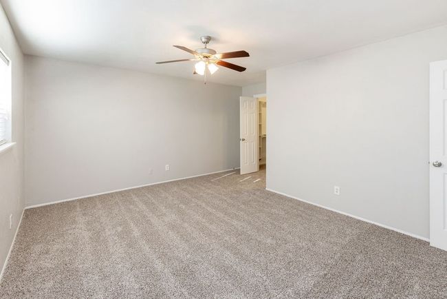 Spare room with baseboards, a ceiling fan, and light carpet | Image 20