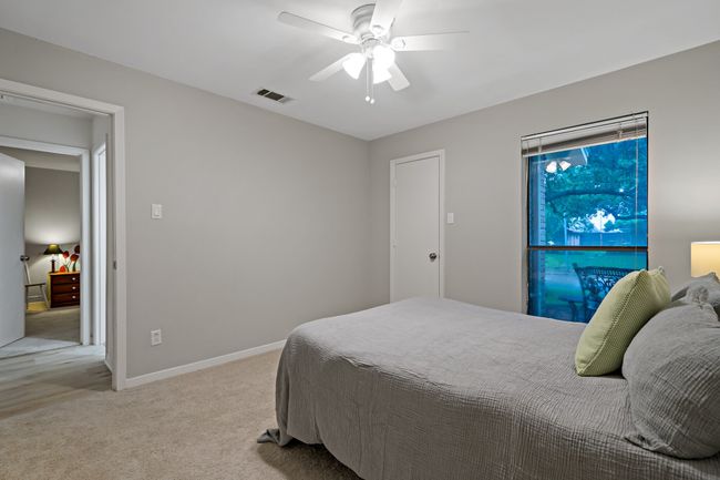 Bedroom featuring ceiling fan, light carpet, and baseboards | Image 20