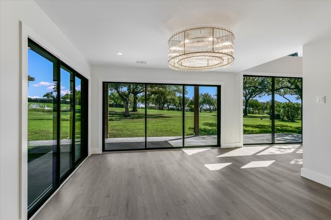 Dining area overlooking golf course with expansive windows | Image 6