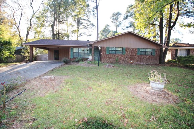 Nice sloped lot. To the left of the carport is a nice sidewalk that leads to the back of the home and patio | Image 33