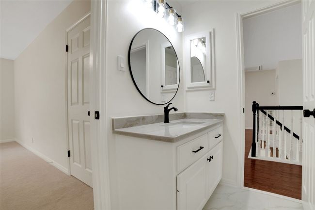 Bathroom featuring vanity, baseboards, and marble finish flooring | Image 26