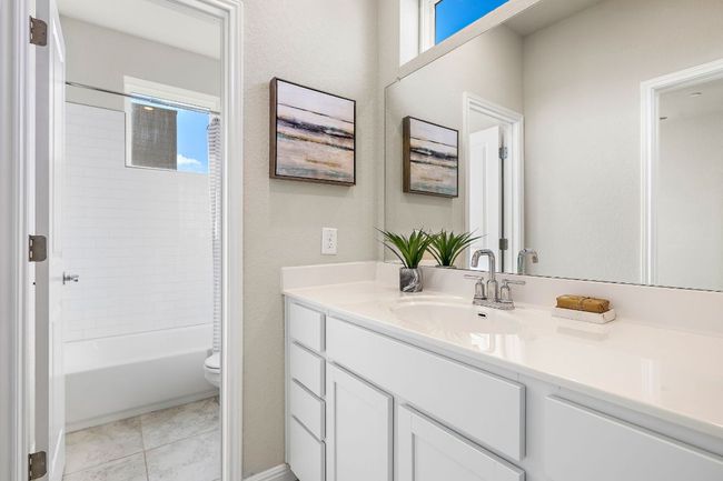 Bathroom featuring plenty of natural light, vanity, shower / bathing tub combination, and toilet | Image 23