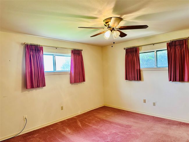 Spare room featuring baseboards, a ceiling fan, and carpet floors | Image 10