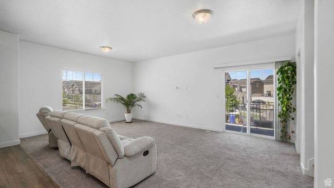 Sitting room with plenty of natural light and wood finished floors | Image 12